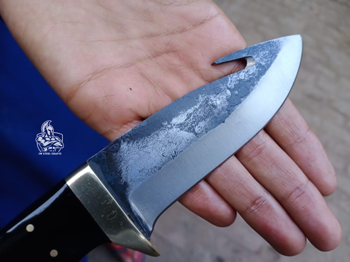 Gut hook knife with wood and brass handle.