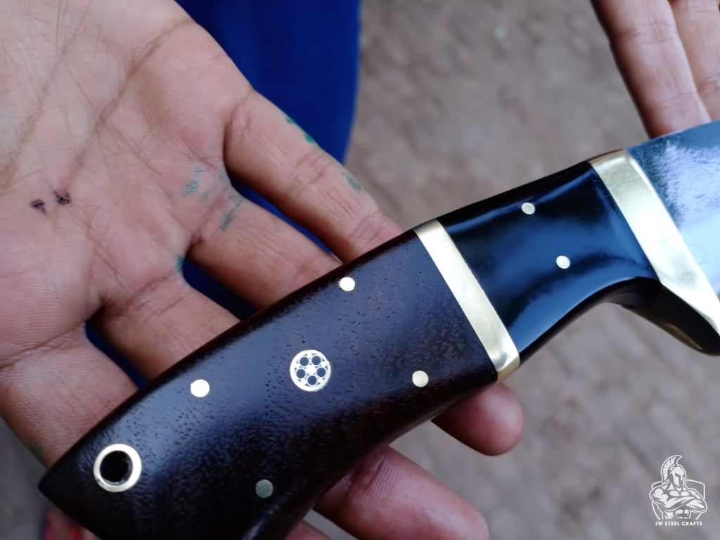 Gut hook knife with wood and brass handle.